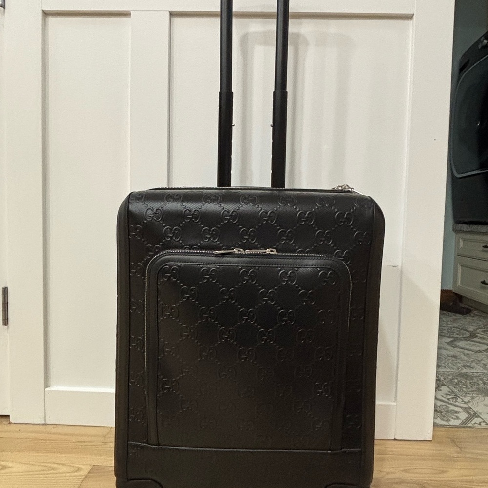 Gucci leather rolling carry on.  AUTHENTIC Largest size you can take on board.